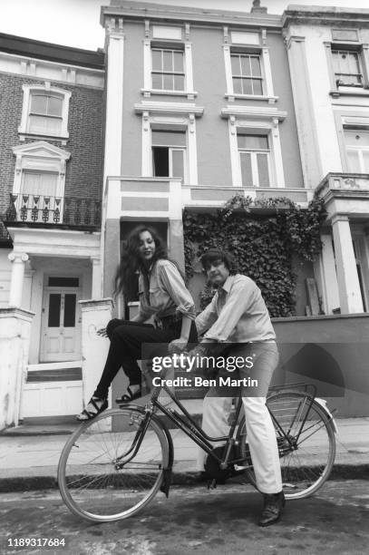 David Bailey and Marie Helvin on a bicycle in front of their London home August 18th, 1977.