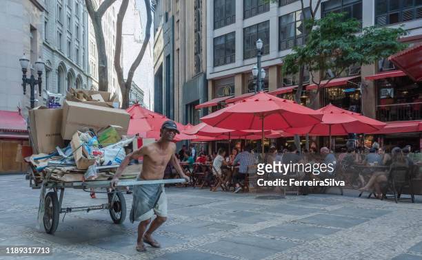 man pulling a cart in downtown sao paulo - unfairness stock pictures, royalty-free photos & images