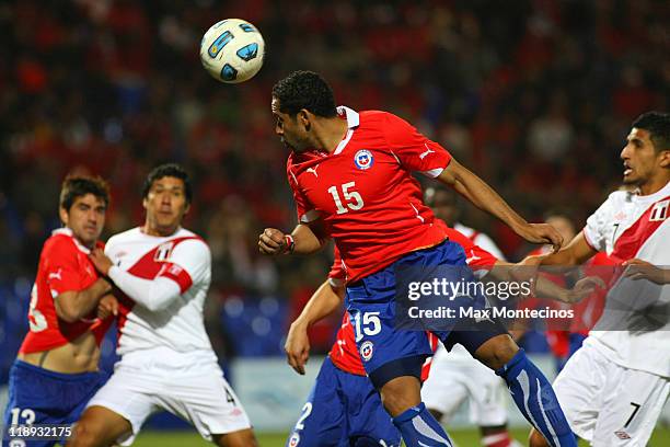 Jean Beausejourof Chile battles for the ball against Josepmir Ballón of Peru during a match as part of group C of 2011 Copa America at Malvinas...