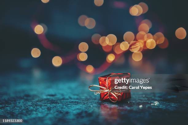 red gift in black background with copyspace - small gift stock pictures, royalty-free photos & images