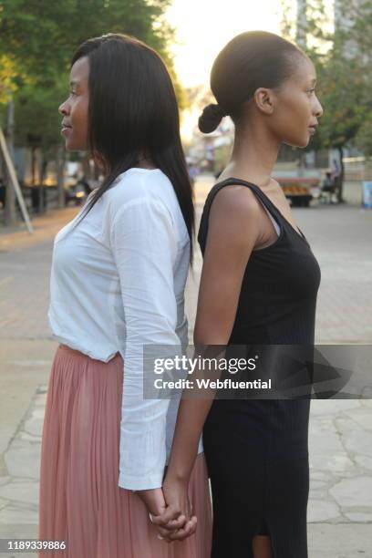 african women holding hands in the street - webfluential bildbanksfoton och bilder