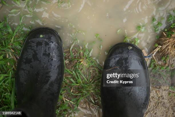 wellington boots outdoors on rainy day - galoshes boots stock pictures, royalty-free photos & images
