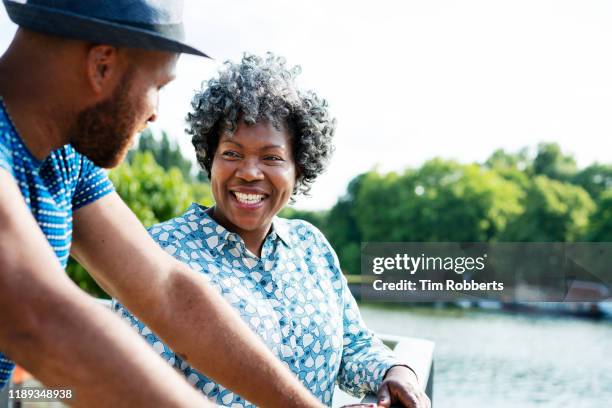 woman and man talking and smiling together - mature woman and son imagens e fotografias de stock