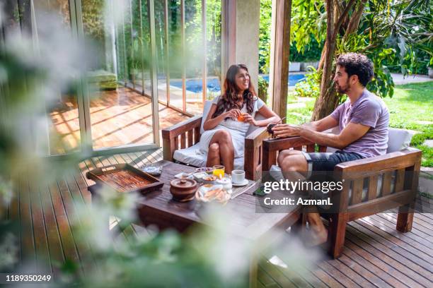 breakfast and relaxing conversation on home deck - outdoor furniture stock pictures, royalty-free photos & images