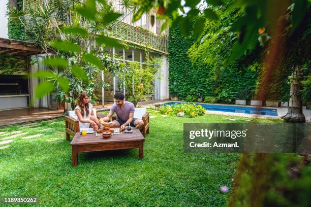 young couple enjoying light breakfast in backyard - breakfast close stock pictures, royalty-free photos & images