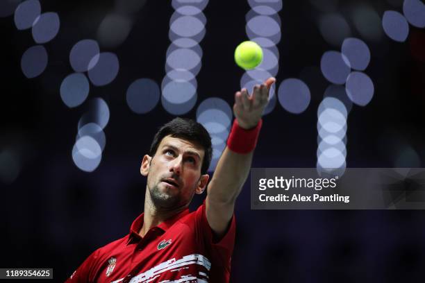 Novak Djokovic of Serbia serves during his quarter final doubles match against Russia on Day Five of the 2019 Davis Cup at La Caja Magica on November...