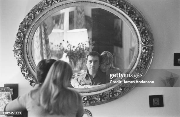 French actress Marina Vlady looking into a mirror at the home she shares with her husband Vladimir Vysotsky, a Russian anti-establishment actor,...