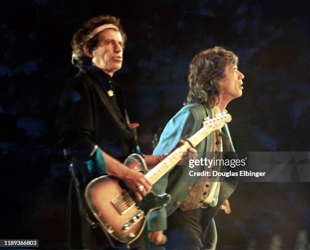 English Rock musician Keith Richards , on guitar, and vocalist Mick Jagger, both of the group the Rolling Stones, perform onstage during the group's...