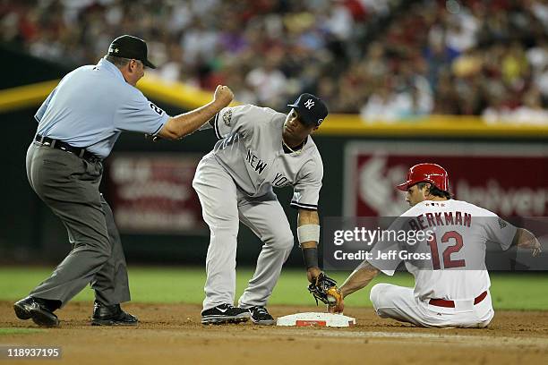 National League All-Star Lance Berkman of the St. Louis Cardinals is tagged out at second base by American League All-Star Robinson Cano of the New...