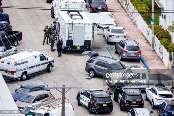 Miami Beach, policemen and SWAT team conducting an arrest.
