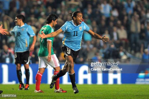 Alvaro Pereira of Uruguay celebrates a scored goal during a match as part of group C of 2011 Copa America at the Ciudad de la Plata Stadium on July...