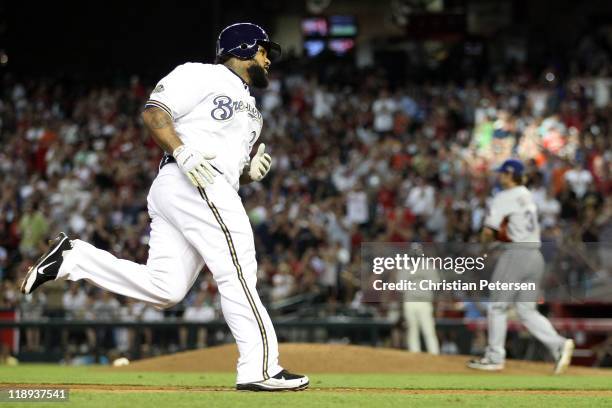 American League All-Star C.J. Wilson of the Texas Rangers stands on the mound as National League All-Star Prince Fielder of the Milwaukee Brewers...