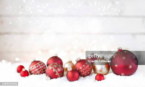 christmas holiday red baubles against an old wood background - conifer cone stock pictures, royalty-free photos & images