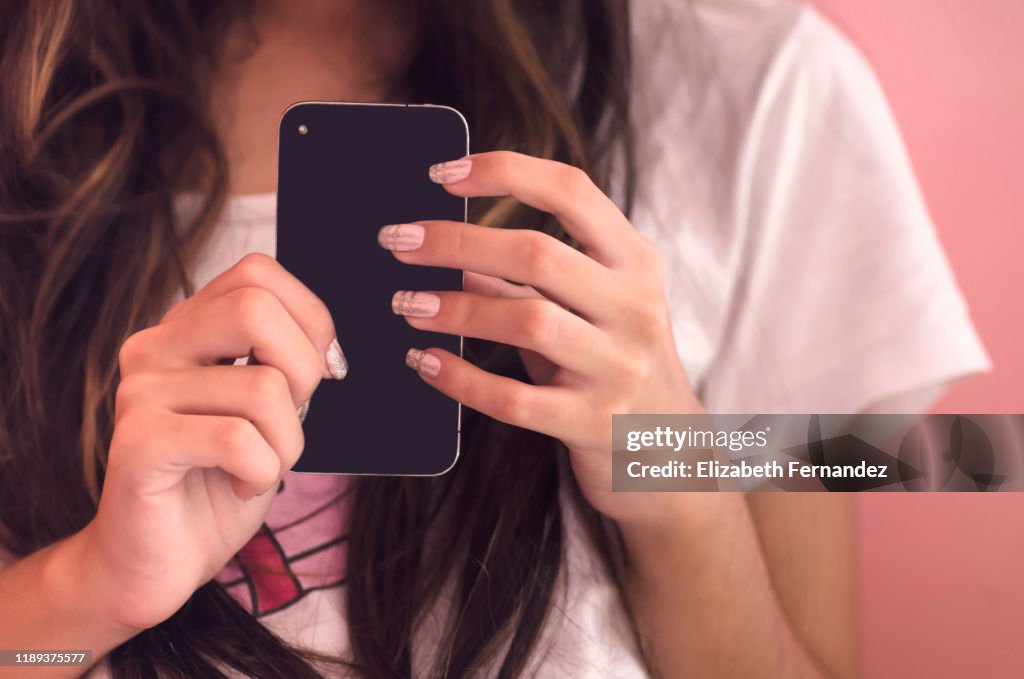 Young woman holding her smart phone