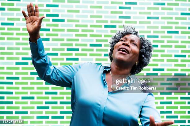 super happy woman with arms in air - celebrating the songs voice of gregg allman portraits stockfoto's en -beelden