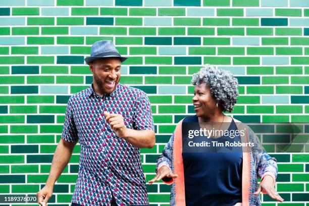 man and woman messing about, dancing - positive healthy middle age woman stock pictures, royalty-free photos & images