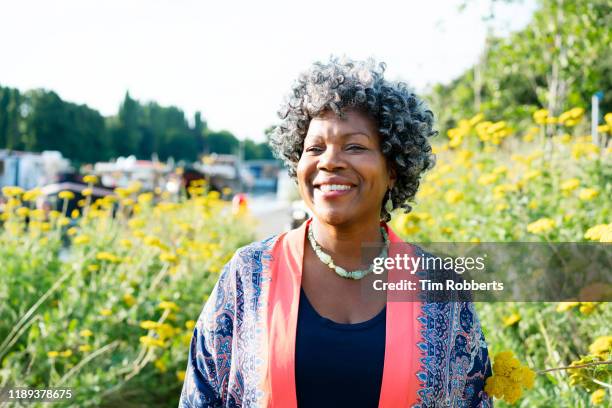smiling woman looking happy - woman walking park spring stock pictures, royalty-free photos & images