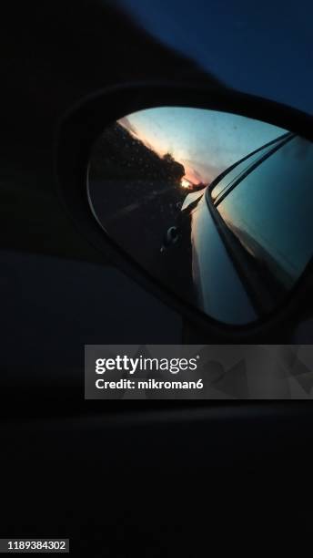 view of a car wing mirror. sunset time - car rear view mirror stock pictures, royalty-free photos & images