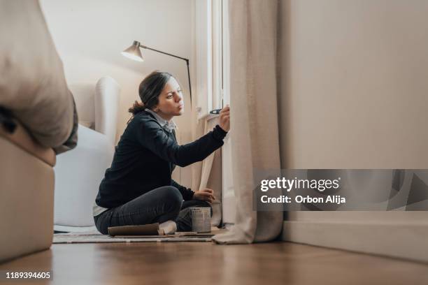 pregnant woman painting windows in white - nursery bedroom stock pictures, royalty-free photos & images