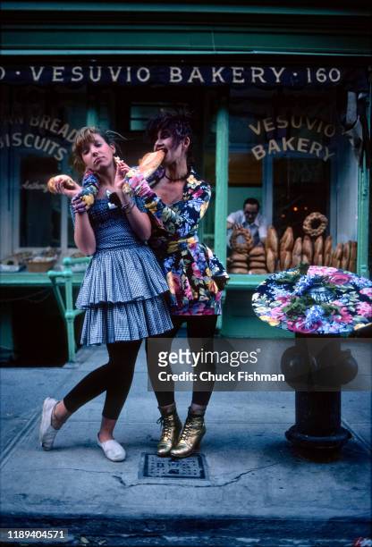 Portrait of American fashion designer Betsey Johnson and her daughter, Lulu, as they pose with loaves of bread outside the Vesuvio Bakery , New York,...