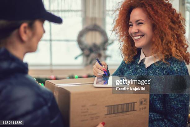 young girl getting parcel on christmas - postal worker stock pictures, royalty-free photos & images