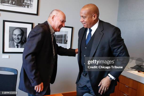 Outgoing Big Ten Commissioner Jim Delany, left, chats with incoming Commissioner Kevin Warren at the Big Ten Conference headquarters in Rosemont,...