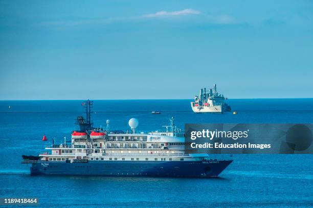 Sea Spirit cruise ship shares Plymouth Sound with RFA Fort Victoria of the Royal Fleet Auxiliary. Plymouth, Devon, UK.