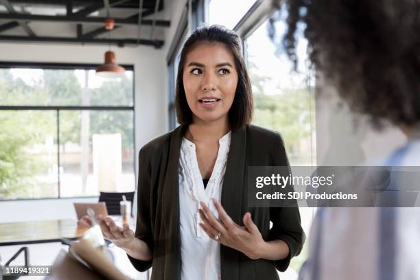 upset businesswoman discusses concerns - coworker conflict stock pictures, royalty-free photos & images