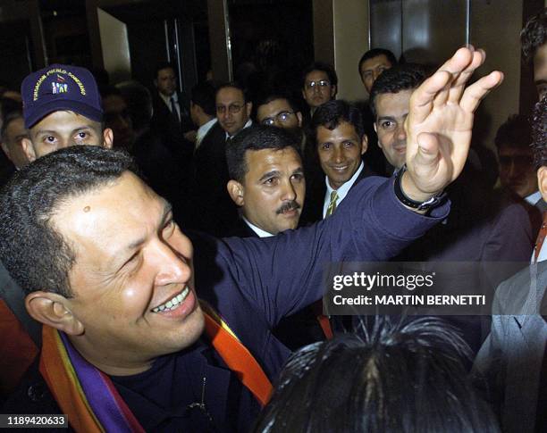 Venezuelan President Hugo Chavez greets supporters ar his arrival to a hotel in Quito, 29 November 2002. Chavez traveled to Ecuador along with Cuban...
