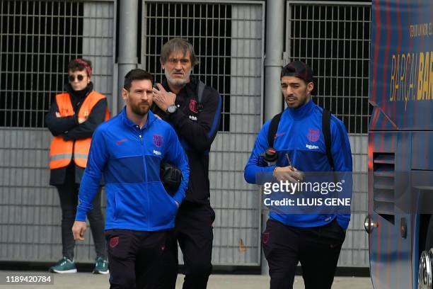 Barcelona's Argentine forward Lionel Messi and Barcelona's Uruguayan forward Luis Suarez leave the Camp Nou Stadium in Barcelona on December 18 ahead...