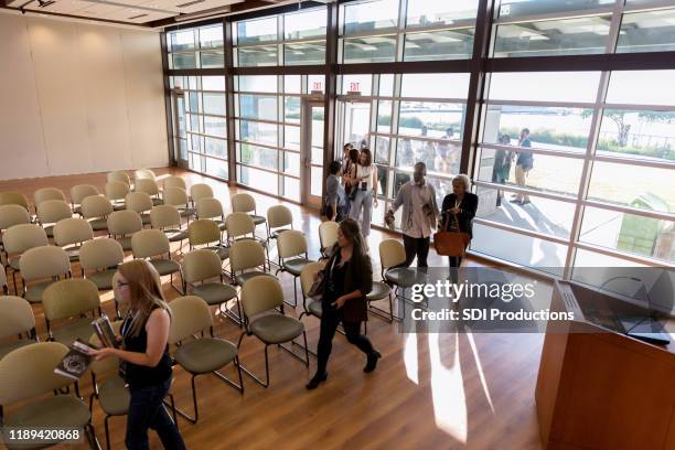 business people enter conference venue - diverse town hall meeting stock pictures, royalty-free photos & images