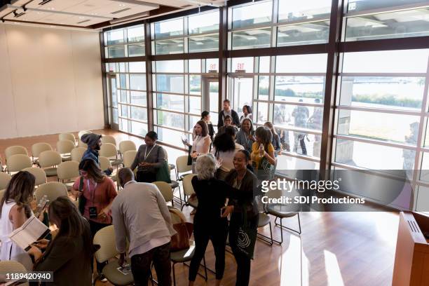 business people enter a conference center - diverse town hall meeting stock pictures, royalty-free photos & images