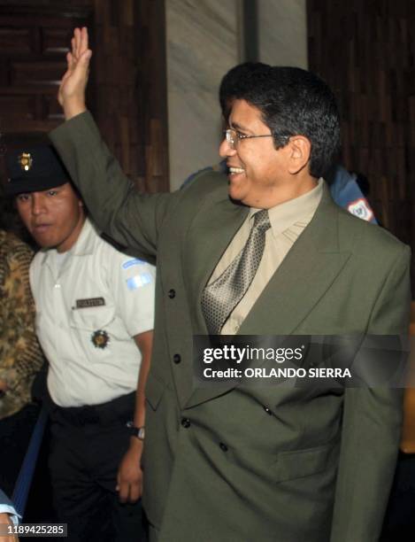 The colonel Juan Valencia waves, 03 October 2002, while leaving the waiting room of the Supreme Court of Justice of Guatemala City, where the...