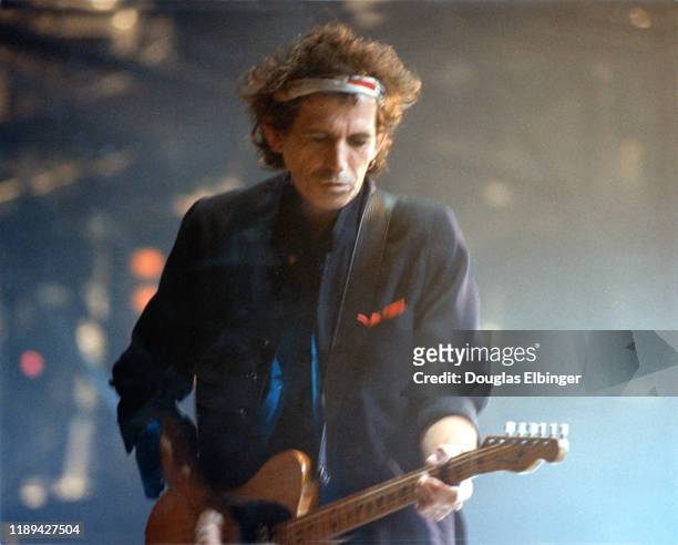 English Rock musician Keith Richards, of the group the Rolling Stones, plays guitar as he performs onstage during the group's 'Voodoo Lounge Tour' at...