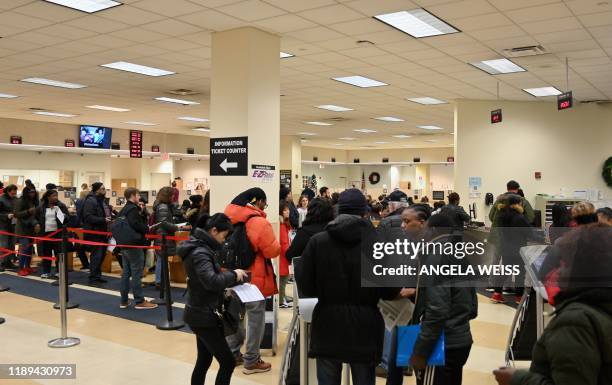 People stand in a long line at the New York State Department of Motor Vehicles office at Atlantic Center in the Brooklyn borough of New York on...