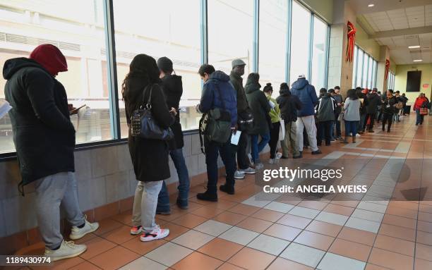 People stand in a long line at the New York State Department of Motor Vehicles office at Atlantic Center in the Brooklyn borough of New York on...
