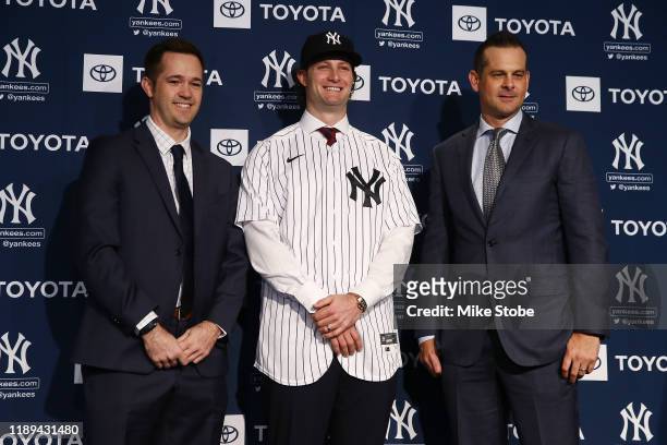 New York Yankee Pitching Coach, Matt Blake, Gerrit Cole, New York Yankee Manager, Aaron Boone of the New York Yankees pose for a photo at Yankee...