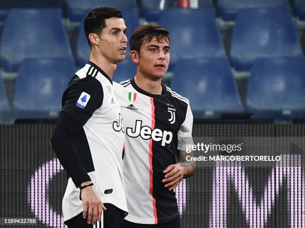 Juventus' Argentine forward Paulo Dybala celebrates with Juventus' Portuguese forward Cristiano Ronaldo after opening the scoring during the Italian...