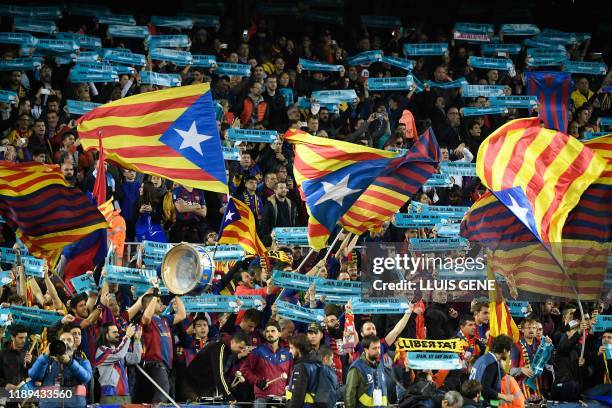 Barcelona's supporters wave Catalan pro-independence "Estelada" flags before the "El Clasico" Spanish League football match between Barcelona FC and...