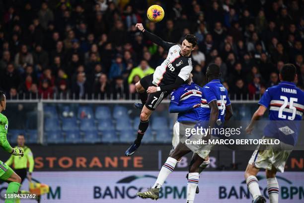 Juventus' Portuguese forward Cristiano Ronaldo scores a header during the Italian Serie A football match Sampdoria vs Juventus on December 18, 2019...