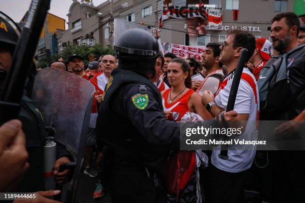 National Police officer argues with a fan of River Plate in the streets of Miraflores neighborhood, ahead of the final match of Copa CONMEBOL...