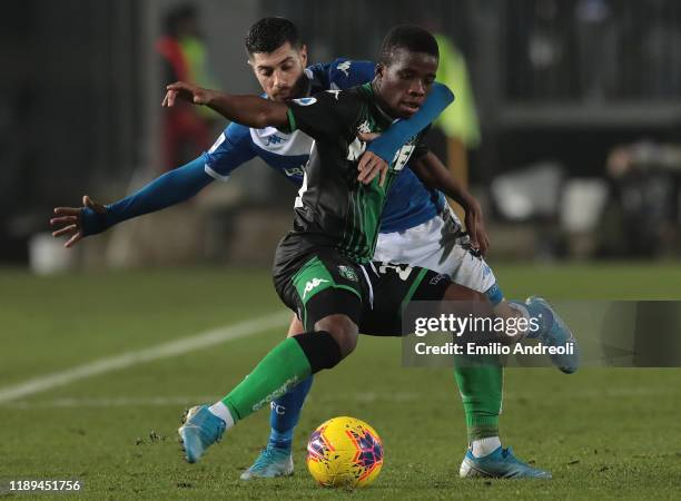 Hamed Junior Traore of US Sassuolo is challenged by Stefano Sabelli of Brescia Calcio during the Serie A match between Brescia Calcio and US Sassuolo...