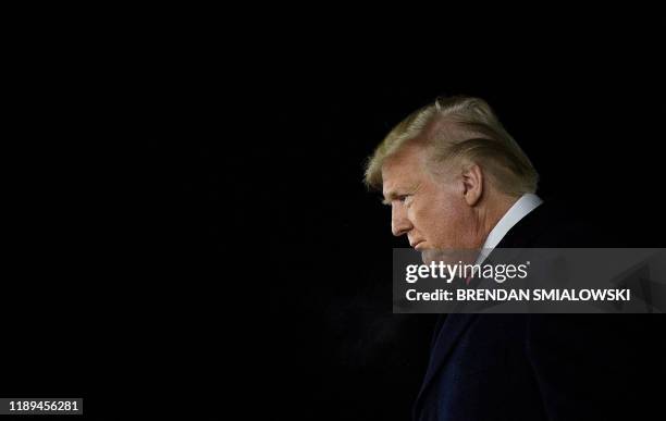 President Donald Trump arrives at W. K. Kellogg Airport as the US House of Representatives debates his impeachment December 18 in Battle Creek,...