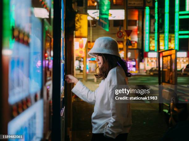 asian woman selecting some drink at vending machine - japan food stock pictures, royalty-free photos & images