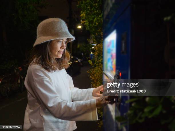 asian woman using auto water machine - we can do it stock pictures, royalty-free photos & images