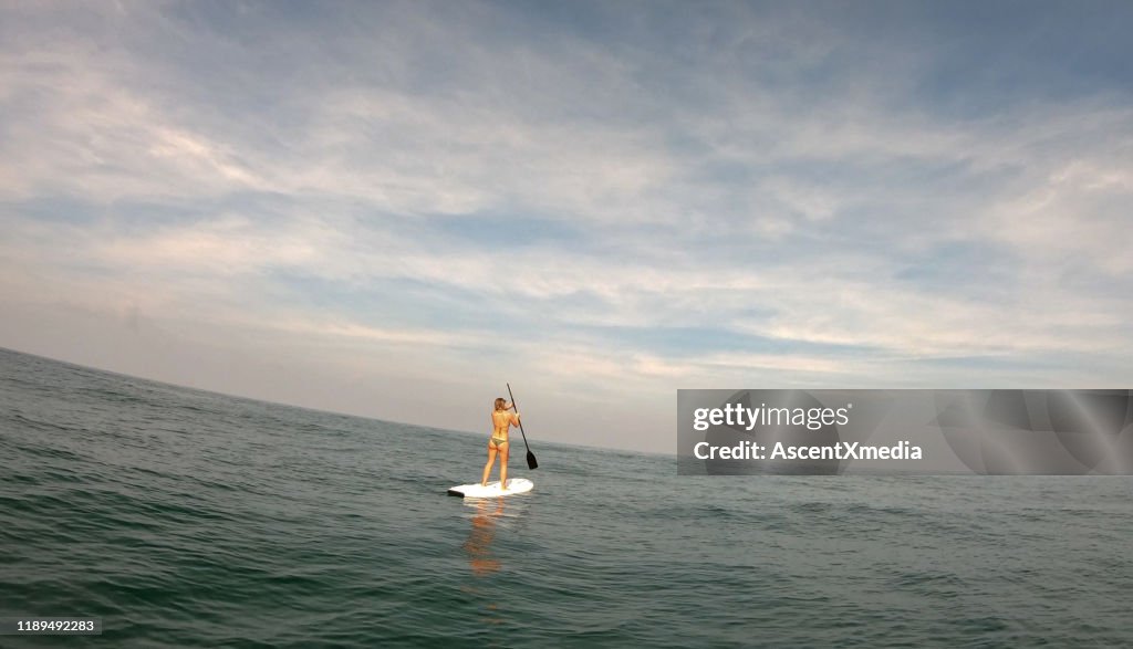Young Woman Paddles Stand Up Paddle Board High-Res Stock Photo - Getty ...