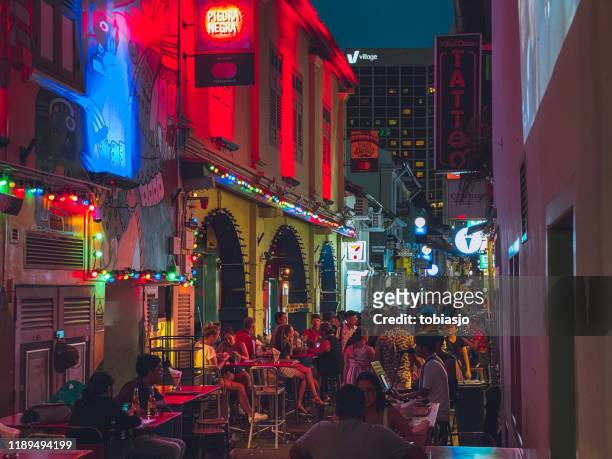 haji lane bar street at night in singapore - busy bar stock pictures, royalty-free photos & images