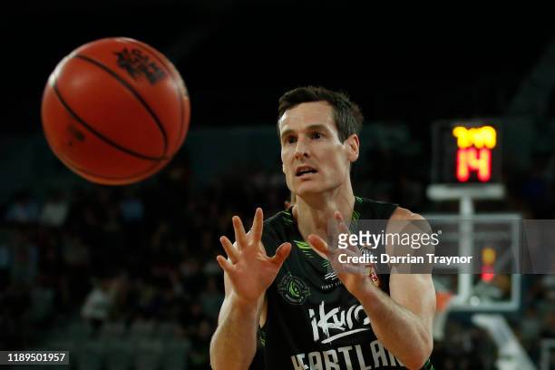 Ben Madgen of the Phoenix gathers the ball during the round 8 NBL match between the South East Melbourne Phoenix and the Sydney Kings at Melbourne...