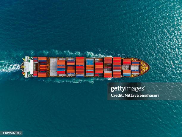 aerial view of cargo ships in containers sailing in the sea. - embarcación industrial fotografías e imágenes de stock