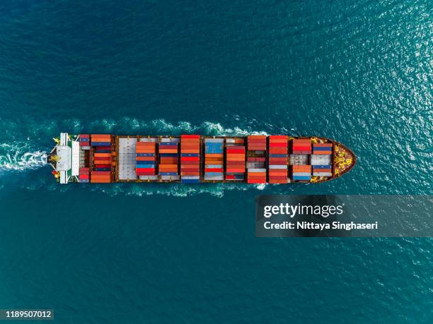aerial view of cargo ships in containers sailing in the sea. - containerschip stockfoto's en -beelden